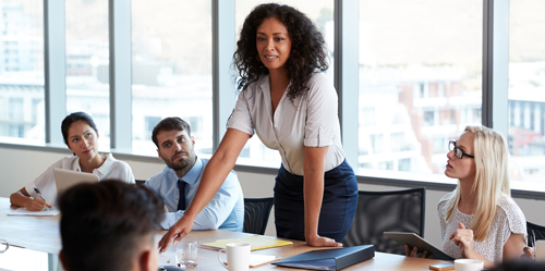 A team participating in a strategic business meeting presentation